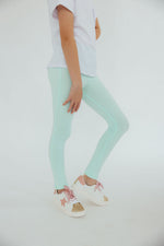Mila & Rose organic pastel green baby leggings.