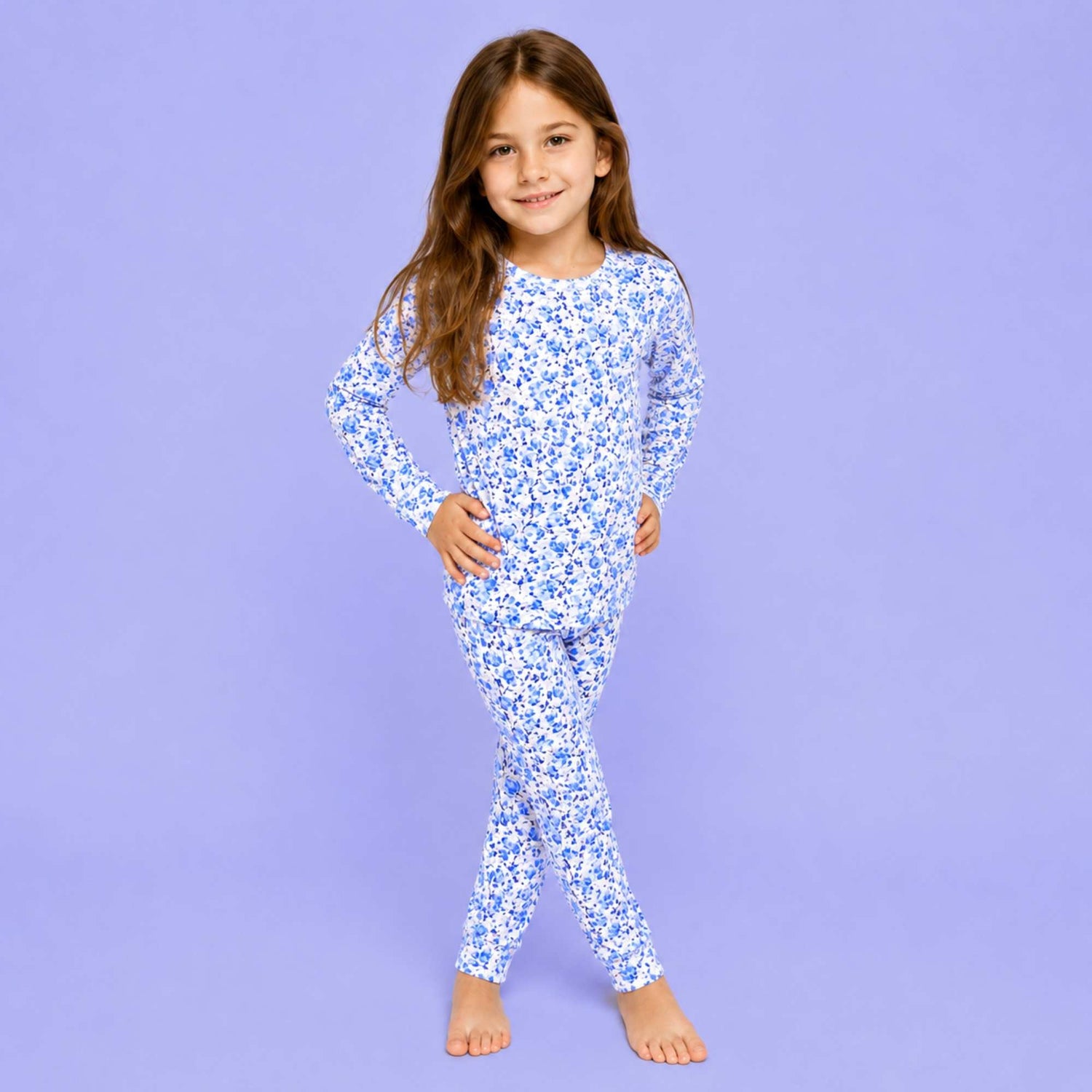 Kids two-piece long-sleeve pajama set in a blue floral petal print with matching pants
