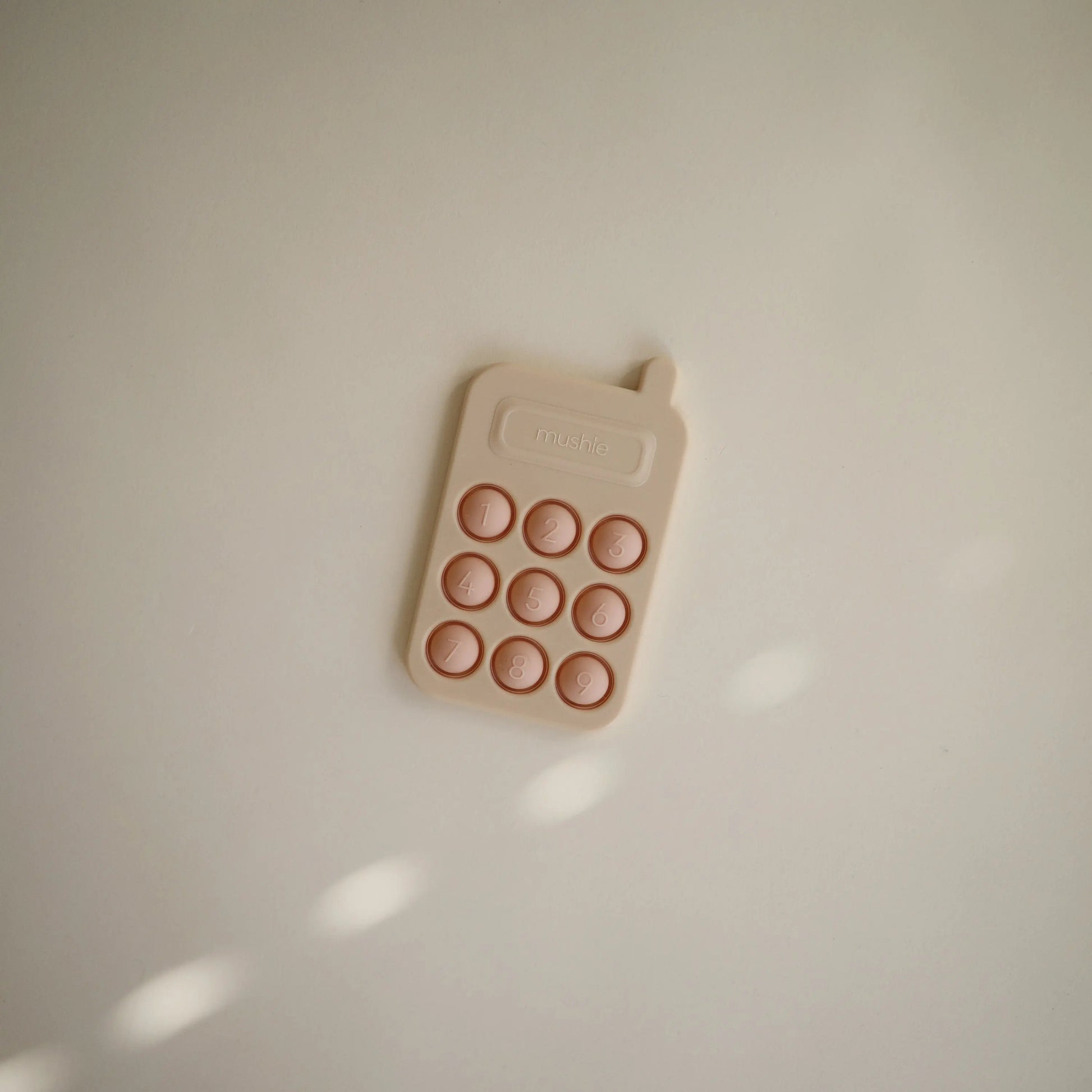 Phone Press Toy for Sensory Exploration and Fine Motor Skill Development Mushie Everetts Place: Online Boutique