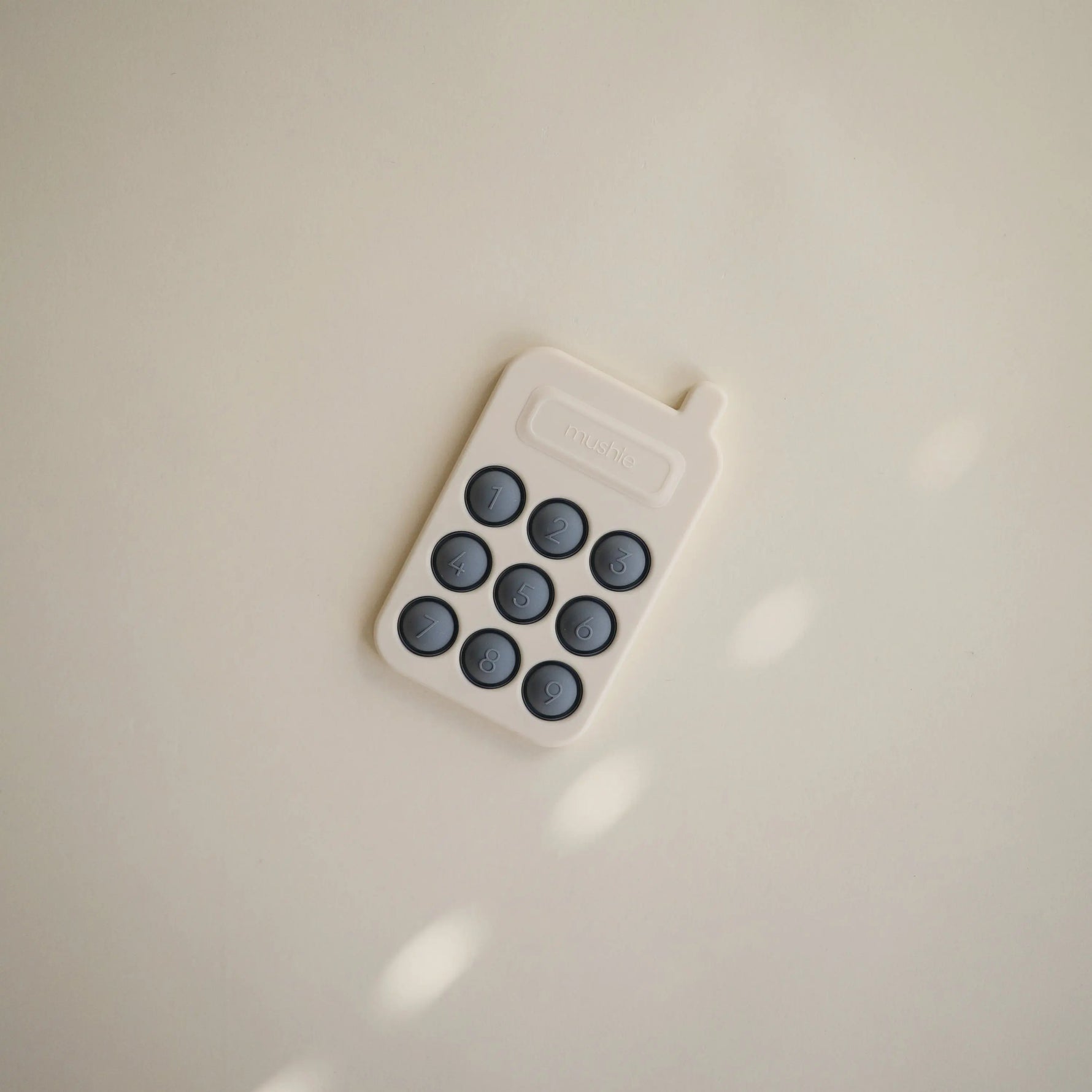 Mushie Phone Press Toy for Sensory Exploration and Fine Motor Skill Development - Baby & Toddler > Baby Toys & Activity Equipment > Push & Pull Toys Press Toy