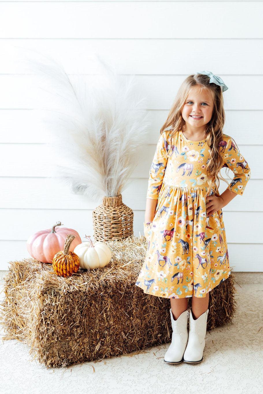 Twirl dress with 3/4 sleeves and pockets in a ponies and poppies print with a full skirt and ballet neckline.