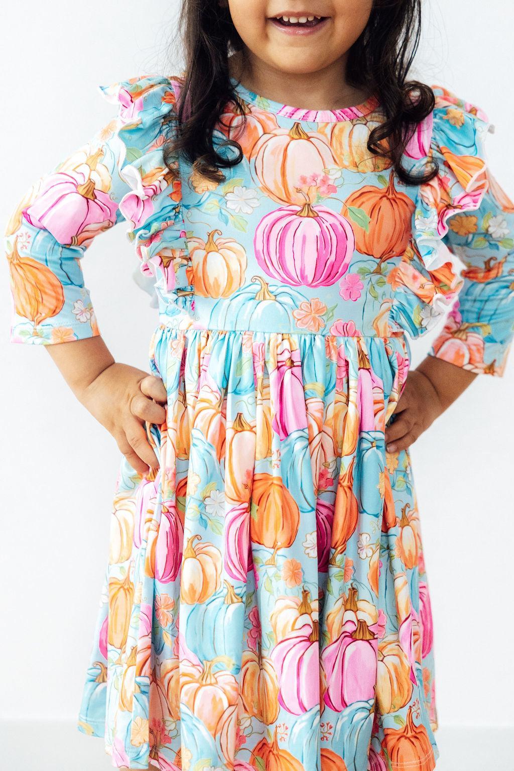 Girls' 3/4 sleeve ruffle twirl dress in a preppy pumpkin print with a full twirling skirt