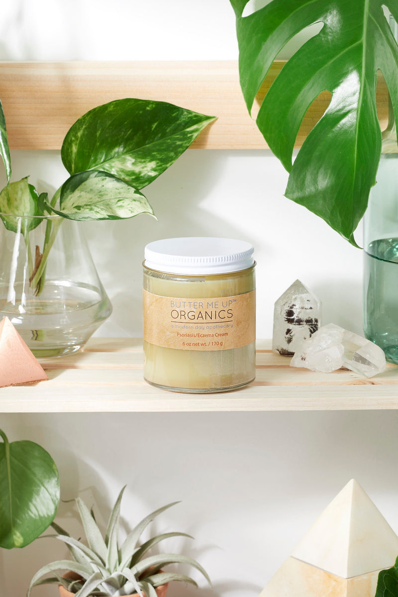Sensitive Skin Cream with Black Seed Oil and Argan on a shelf with plants.