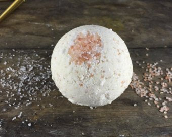 Sensitive Skin Gift Set bath bomb with pink salt on wooden surface.