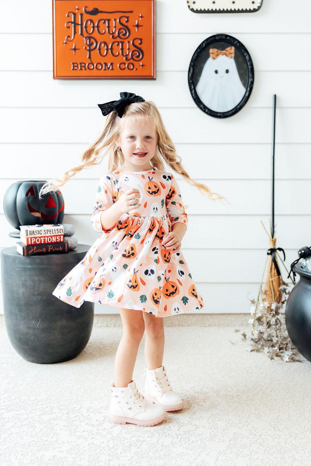 Girls' 3/4 sleeve twirl dress in pumpkin print with pockets and a full twirl skirt