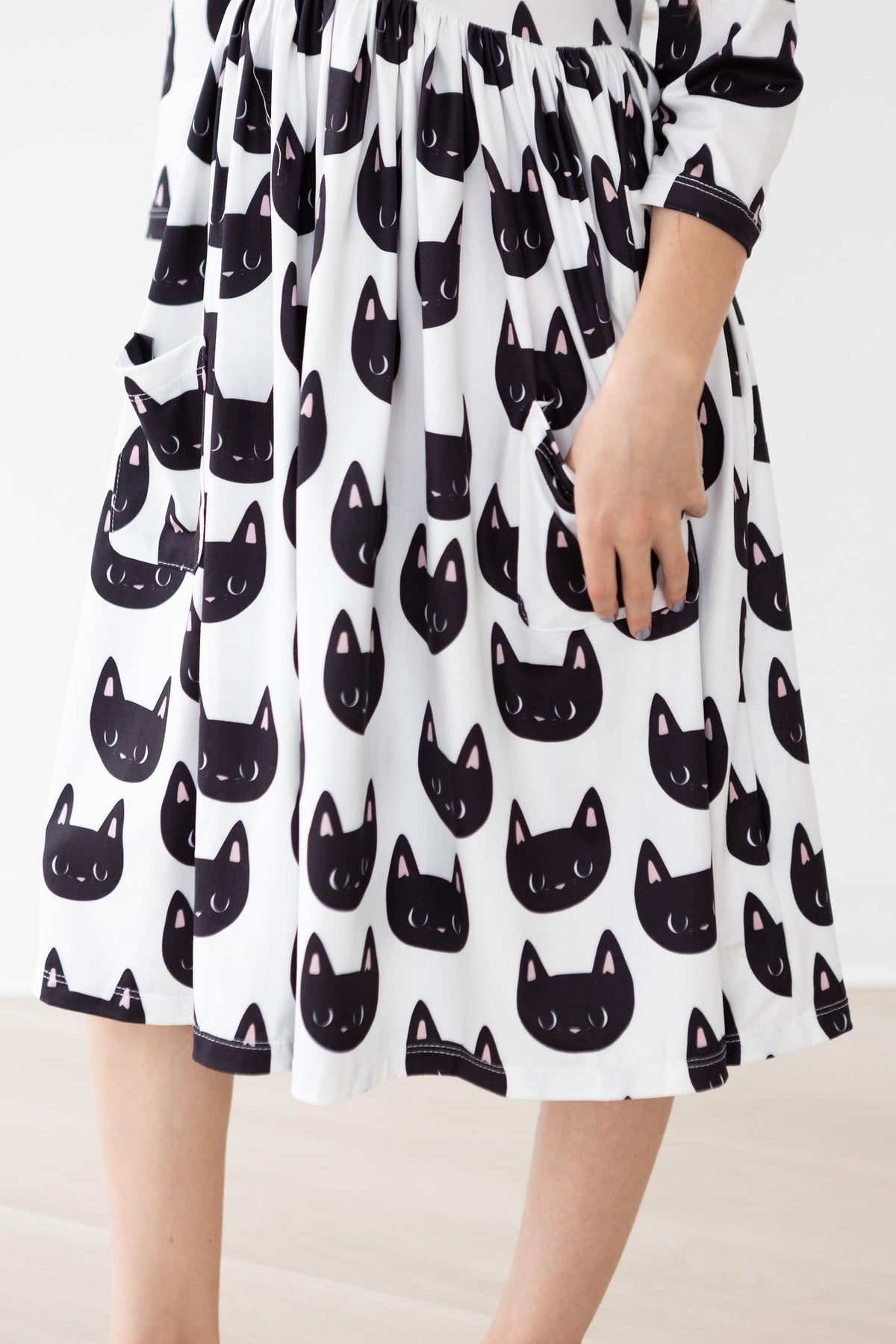 3/4 sleeve twirl dress with a cat print, ballet neckline, pockets, and a full twirl skirt