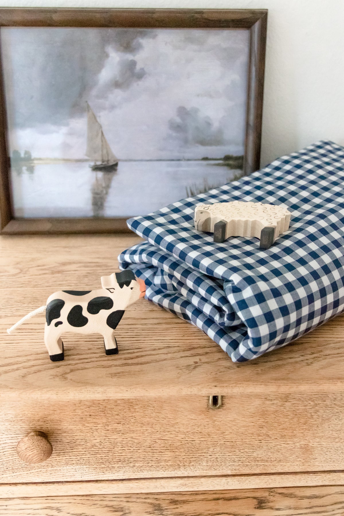 Little Mae & Co navy gingham crib quilted blanket.