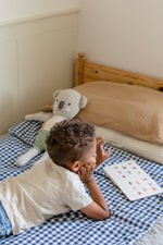 Little Mae & Co navy gingham quilted crib blanket.