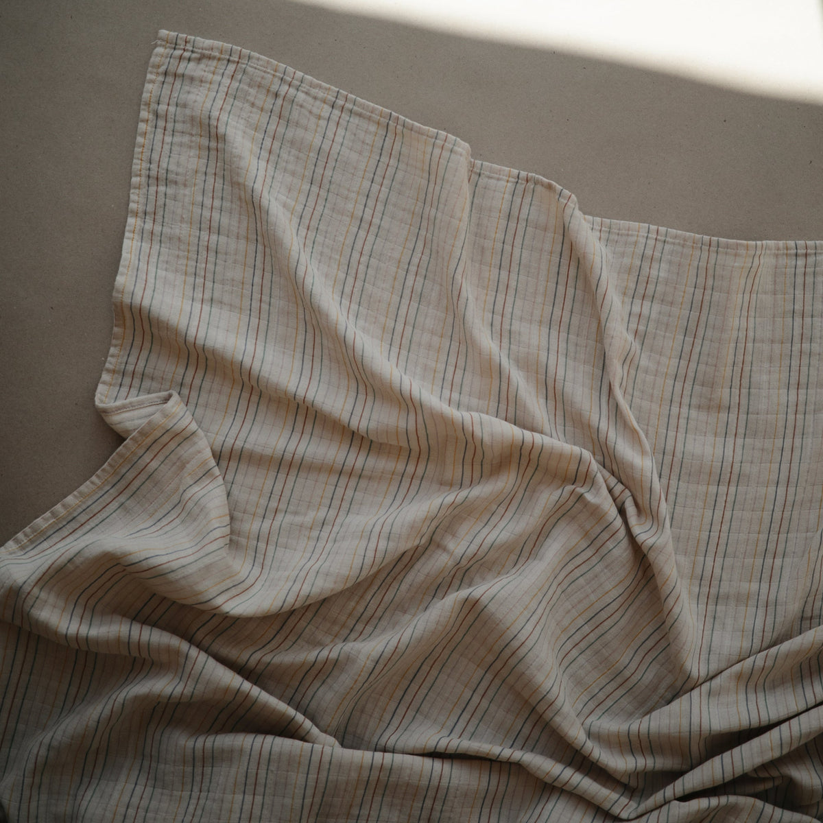 Mushie organic cotton muslin swaddle blanket for baby.