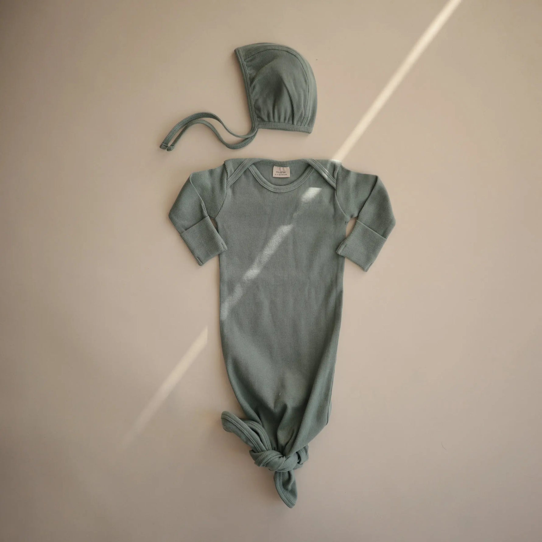 Mushie Ribbed Baby Bonnet Made with Organic Cotton for Warmth and Comfort - Apparel & Accessories > Clothing > Baby & Toddler Clothing > Baby One-Pieces Baby Clothes