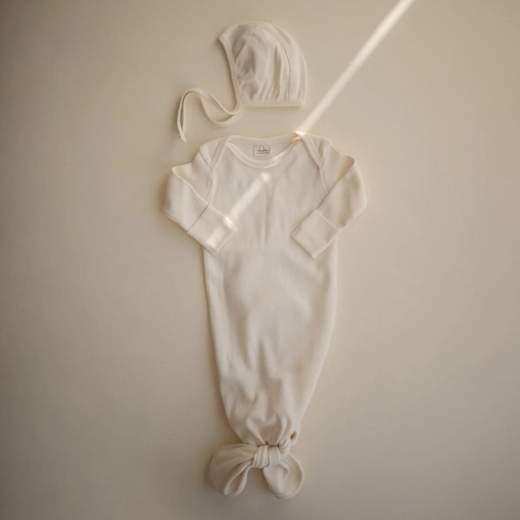Mushie Ribbed Baby Bonnet Made with Organic Cotton for Warmth and Comfort - Apparel & Accessories > Clothing > Baby & Toddler Clothing > Baby One-Pieces Baby Clothes