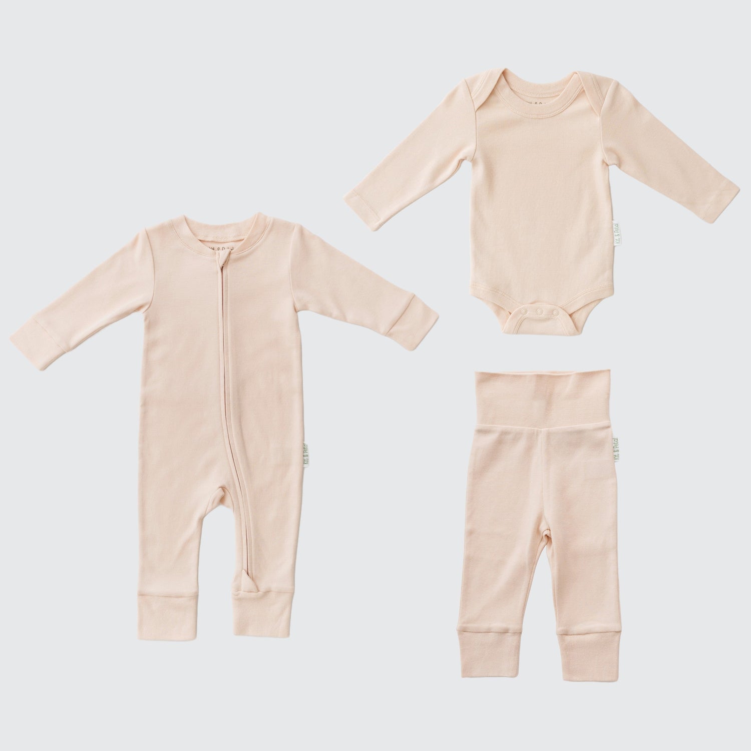 Three-piece baby outfit set in rosy peach: long sleeve romper, bodysuit, and fold-over pants