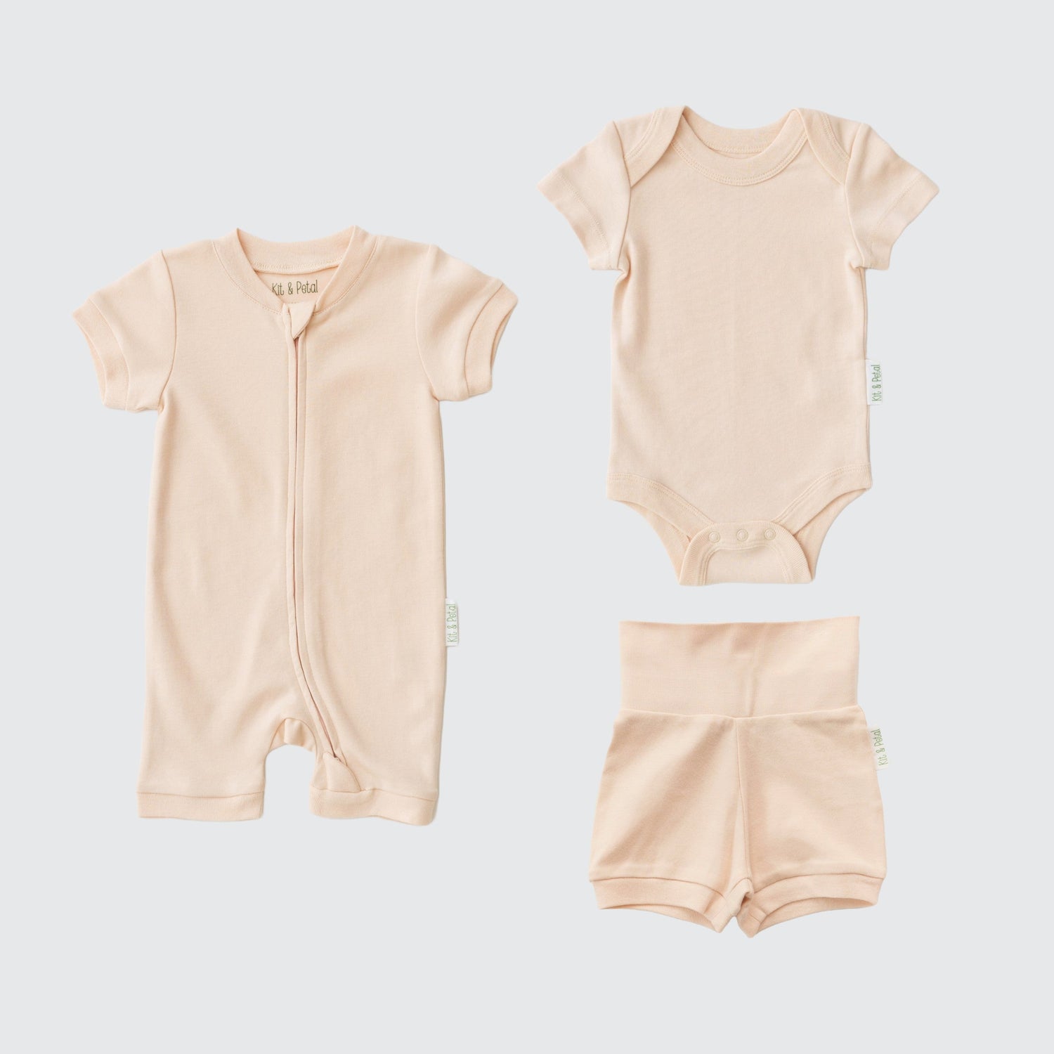 Three-piece baby set in rosy peach: short sleeve romper, bodysuit, and fold-over shorts