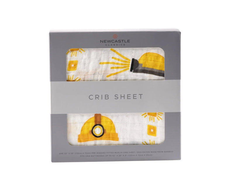 Bamboo muslin crib sheet with hard hat design in packaging.