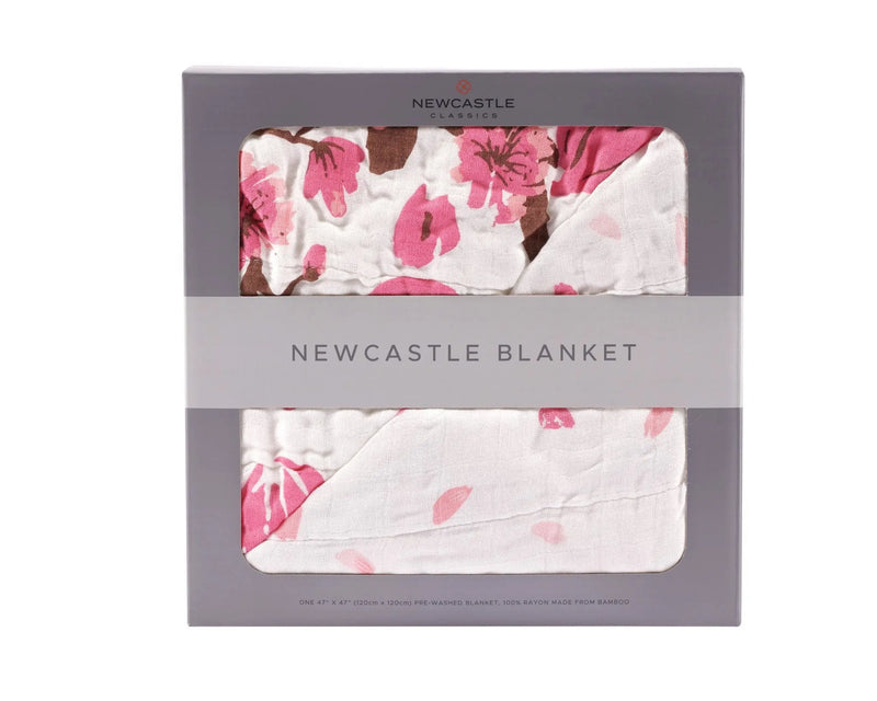 Cherry Blossom Bamboo Muslin Newcastle Blanket in packaging, featuring a pink floral pattern.