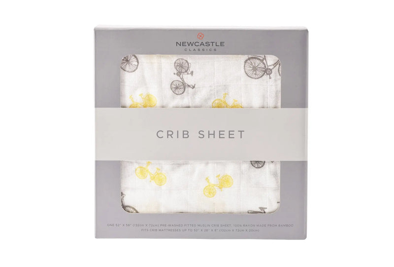 Vintage Bicycle Bamboo Muslin Crib Sheet in packaging with bicycle pattern design.