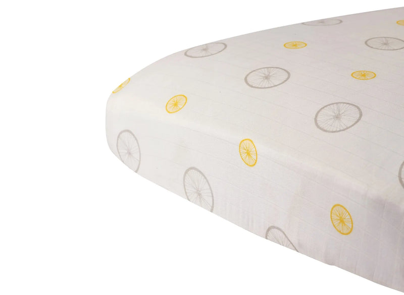 Vintage Wheel Bamboo Muslin crib sheet with wheel pattern, fitting standard crib mattress, soft and breathable.