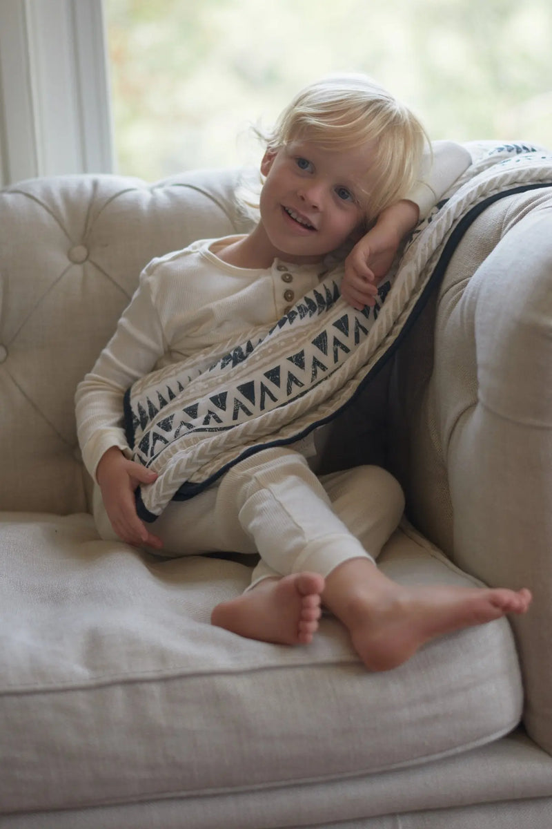 Pyramid Cotton Muslin Newcastle Blanket in use, cozy and cuddly for children.