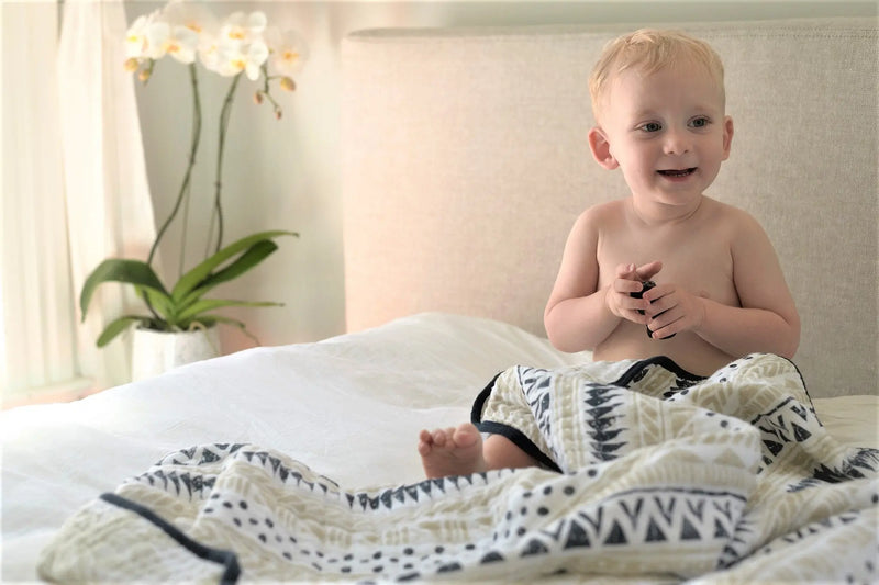 Cozy Pyramid and Boho Fields cotton muslin blanket with playful patterns, perfect for kids.