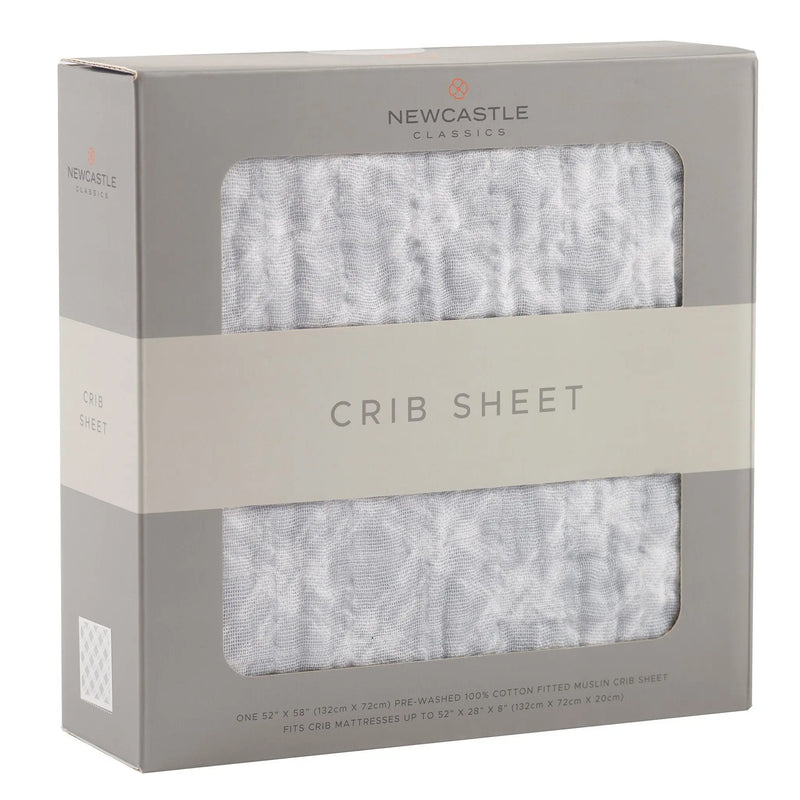Glacier Grey Plaid Cotton Muslin Crib Sheet in packaging.