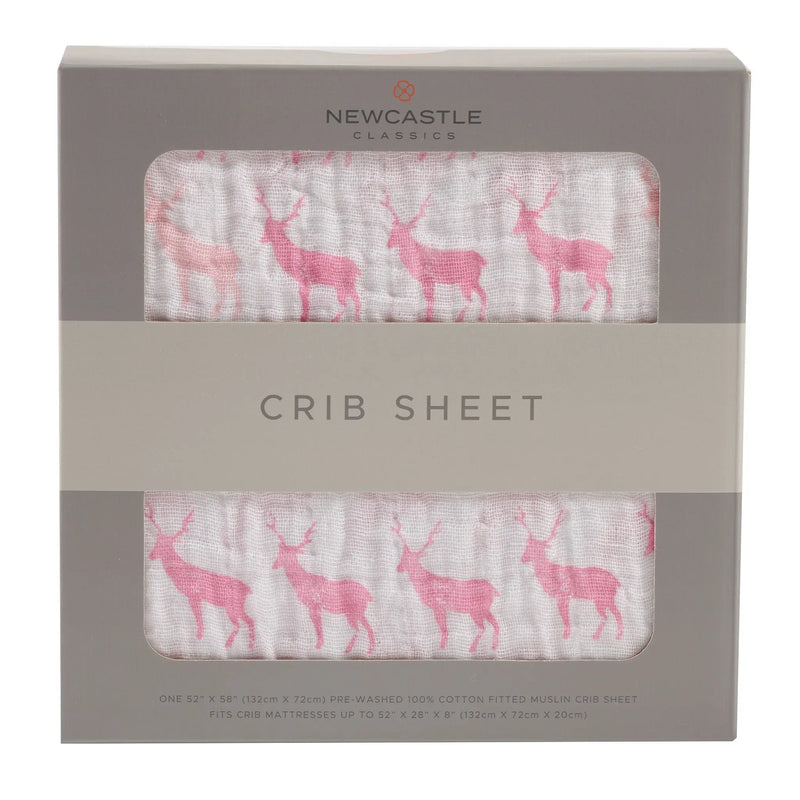 Pink deer cotton muslin crib sheet in packaging.
