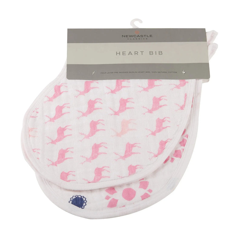 Two pink cotton heart bibs with playful designs, made from soft, natural cotton muslin.