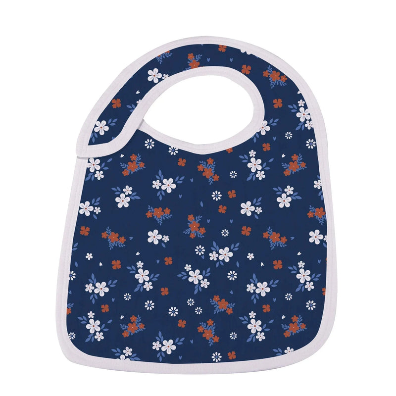 Blue floral bib with white trim made from soft bamboo muslin, featuring front snaps for an adjustable fit.