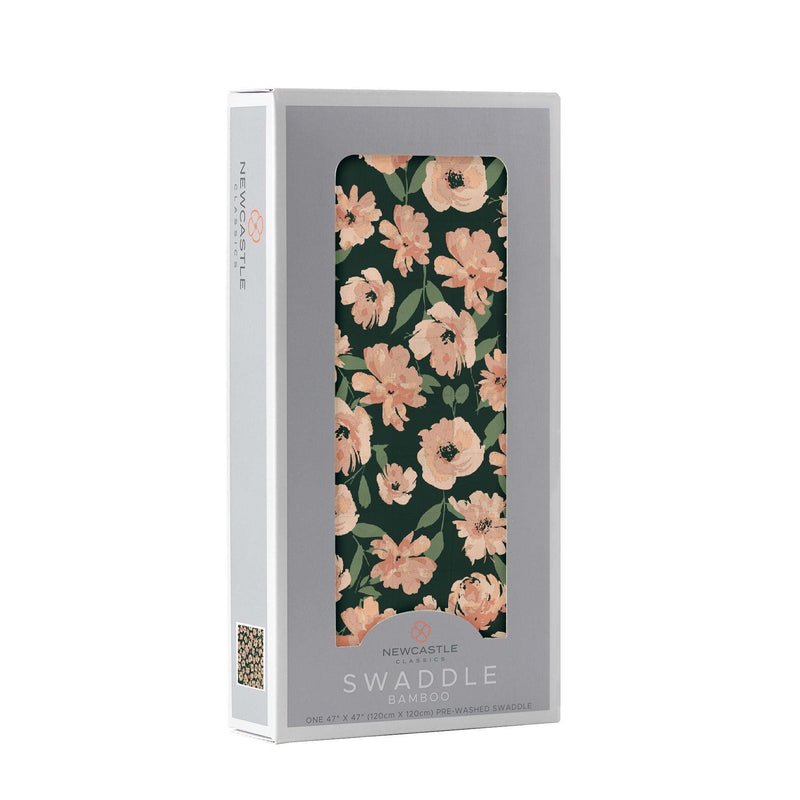 Canyon Sunset Flowers Bamboo Swaddle in packaging with floral design featuring soft peach flowers on a dark background.