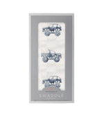 Cotton muslin swaddle blanket in indigo with a monster truck pattern spread flat