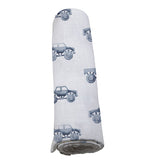 Soft indigo cotton swaddle with monster trucks pattern by Newcastle Classics.