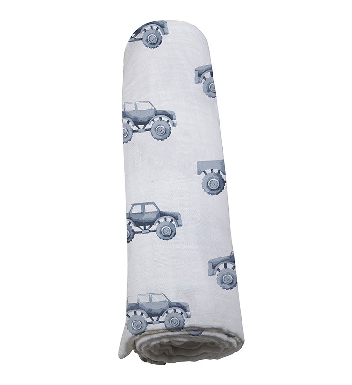 Soft indigo cotton swaddle with monster trucks pattern by Newcastle Classics.