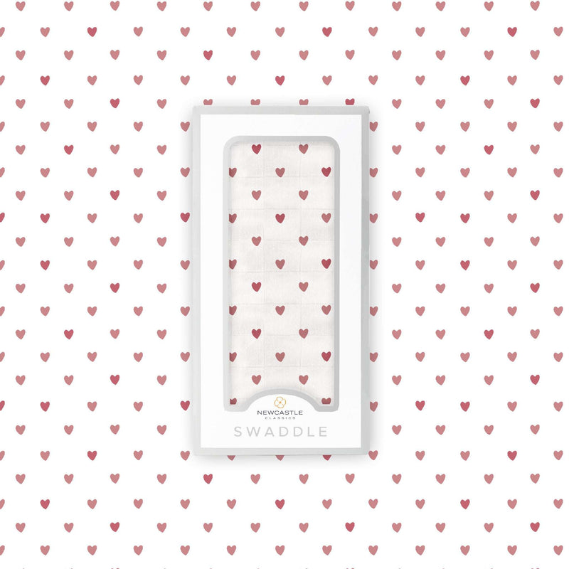 Two Hearts Bamboo Swaddle with heart pattern, made from soft natural bamboo muslin, in packaging.