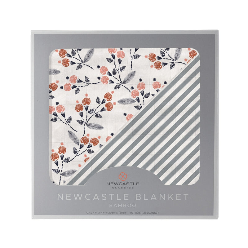 Dahlia Floral and Finley Stripe bamboo muslin blanket in packaging.