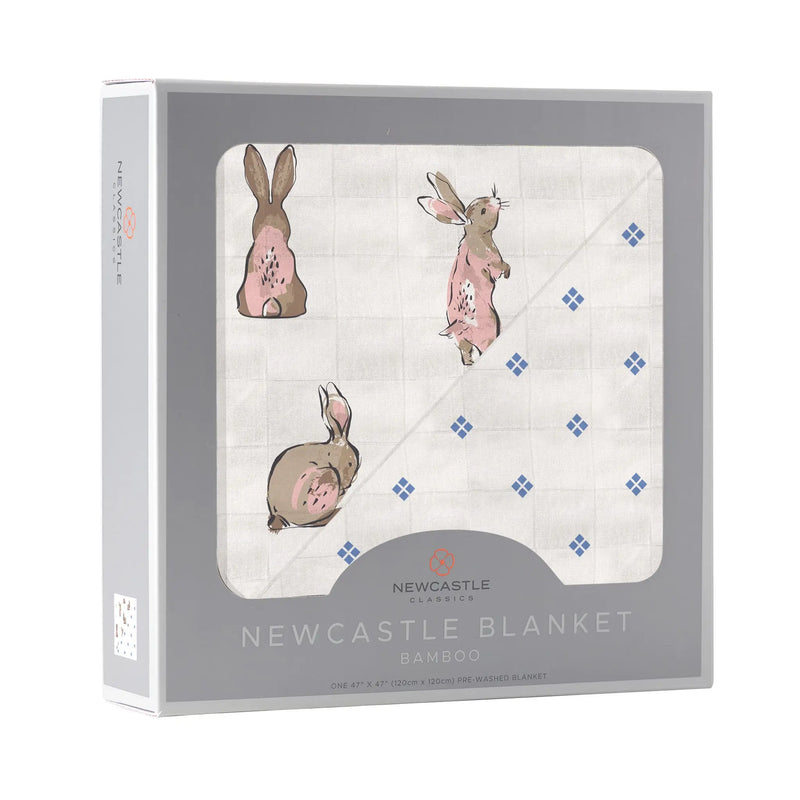 Powder Pink Bunnies and Periwinkle Diamond Polka Dot Bamboo Newcastle Blanket in packaging.