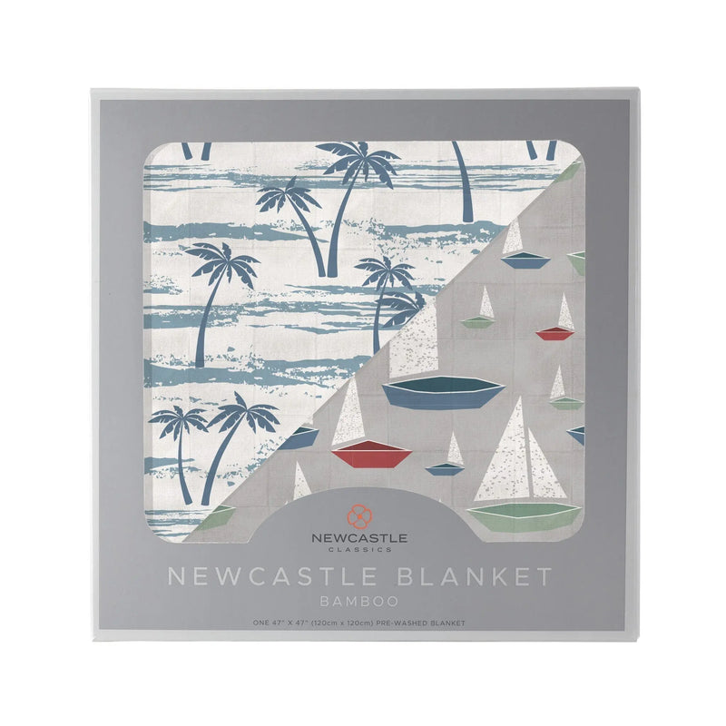 Ocean palm trees and marina sailboats print bamboo muslin blanket in box.