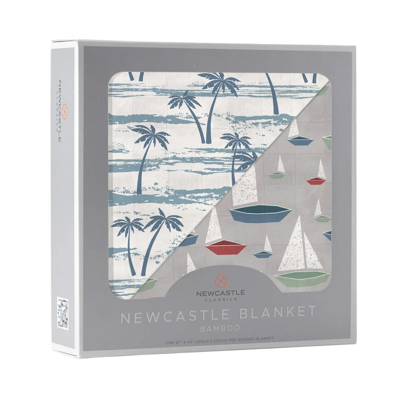 Ocean Palm Trees and Marina Sailboats Bamboo Newcastle Blanket in packaging, featuring a soft, breathable design with palm tree and sailboat patterns.