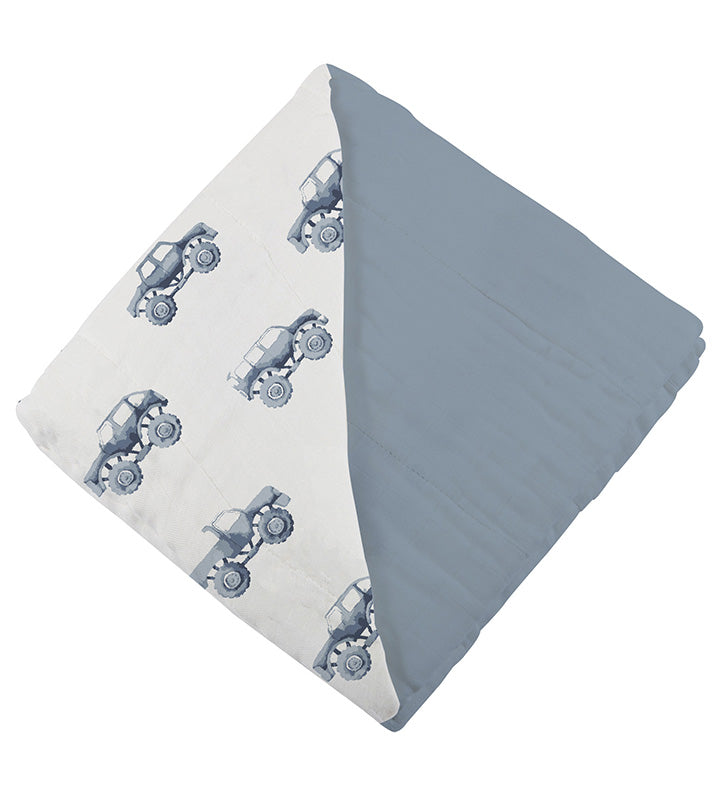 Indigo monster trucks and blue fog cotton Newcastle blanket with breathable muslin fabric.