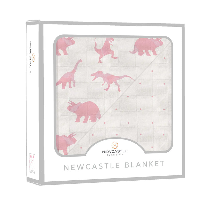 Pink dinosaur and polka dot bamboo muslin blanket in packaging.