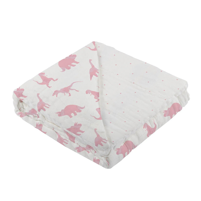 Pink dinosaur and polka dot bamboo muslin blanket folded neatly.