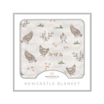 Baby blanket in bamboo muslin with a farm chicken print spread out flat