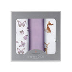 Three folded muslin swaddle blankets printed with foxes and butterflies in a mountain meadow theme