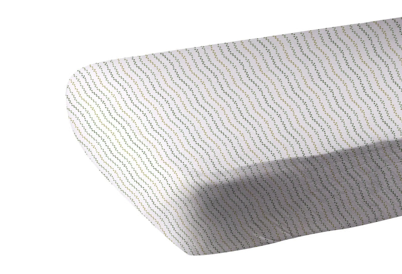 Dino Feet Cotton Muslin Crib Sheet on mattress with dotted pattern, 100% natural cotton.