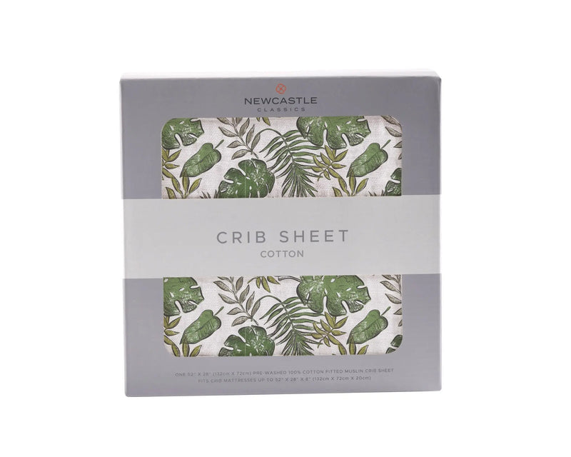 Tropical Forest Cotton Muslin Crib Sheet in box with green leaf pattern.