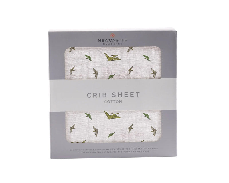 Pteranodon cotton muslin crib sheet in packaging with dinosaur print, made of 100% natural cotton, size 28"x52".