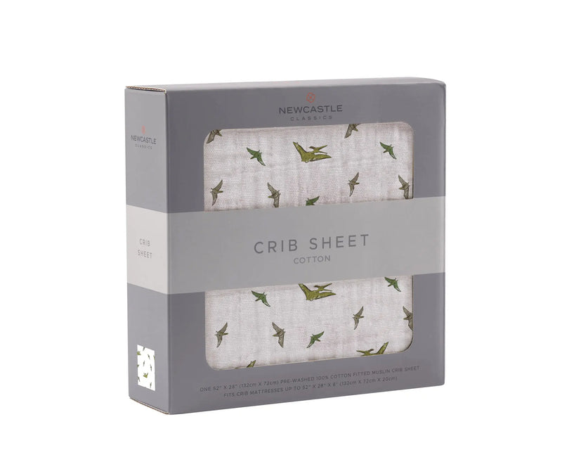 Pteranodon cotton muslin crib sheet in packaging, soft breathable material, fits standard crib mattresses.