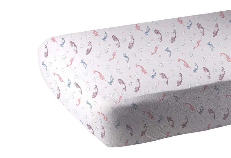 Mermaids Bamboo Muslin crib sheet with soft breathable fabric and colorful mermaid design.