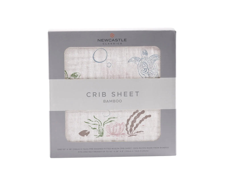 Turtles Bamboo Muslin crib sheet in packaging with marine design.