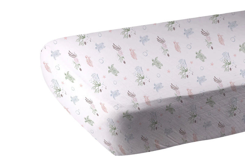 Turtles Bamboo Muslin crib sheet with turtle pattern, soft and breathable, fits standard crib mattress.
