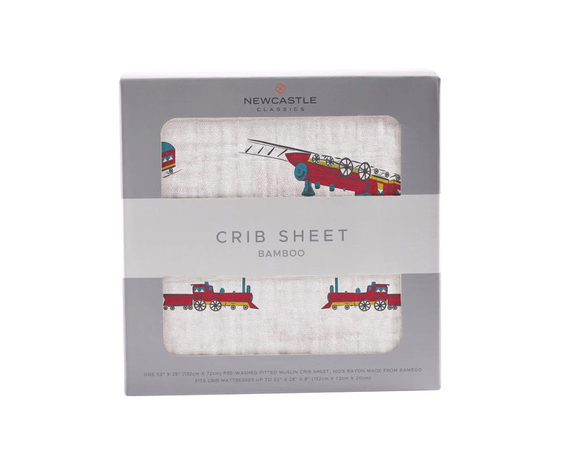 Vintage steam train bamboo crib sheet in packaging, featuring colorful train illustrations.