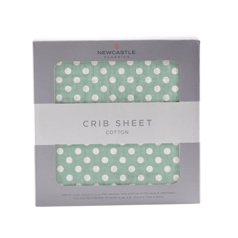 Jade polka dot cotton muslin crib sheet in packaging.